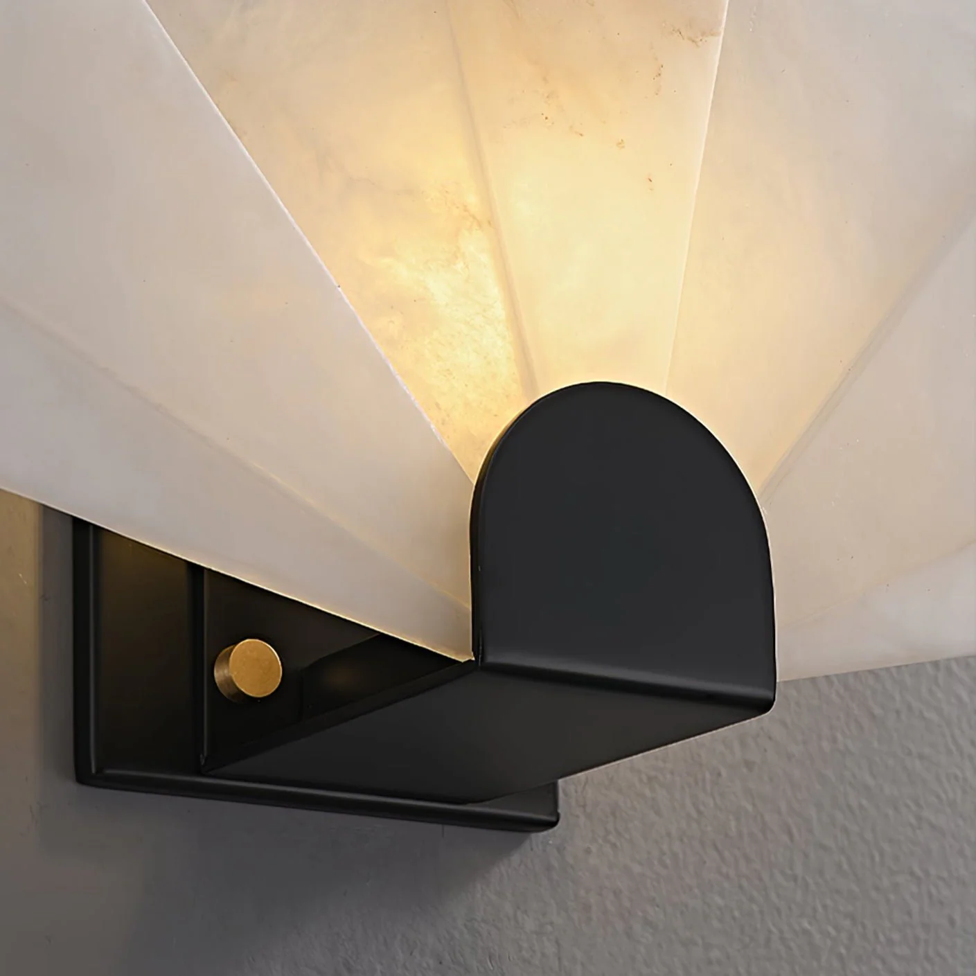 SOLEIL alabaster Wall sconce lit in a living room