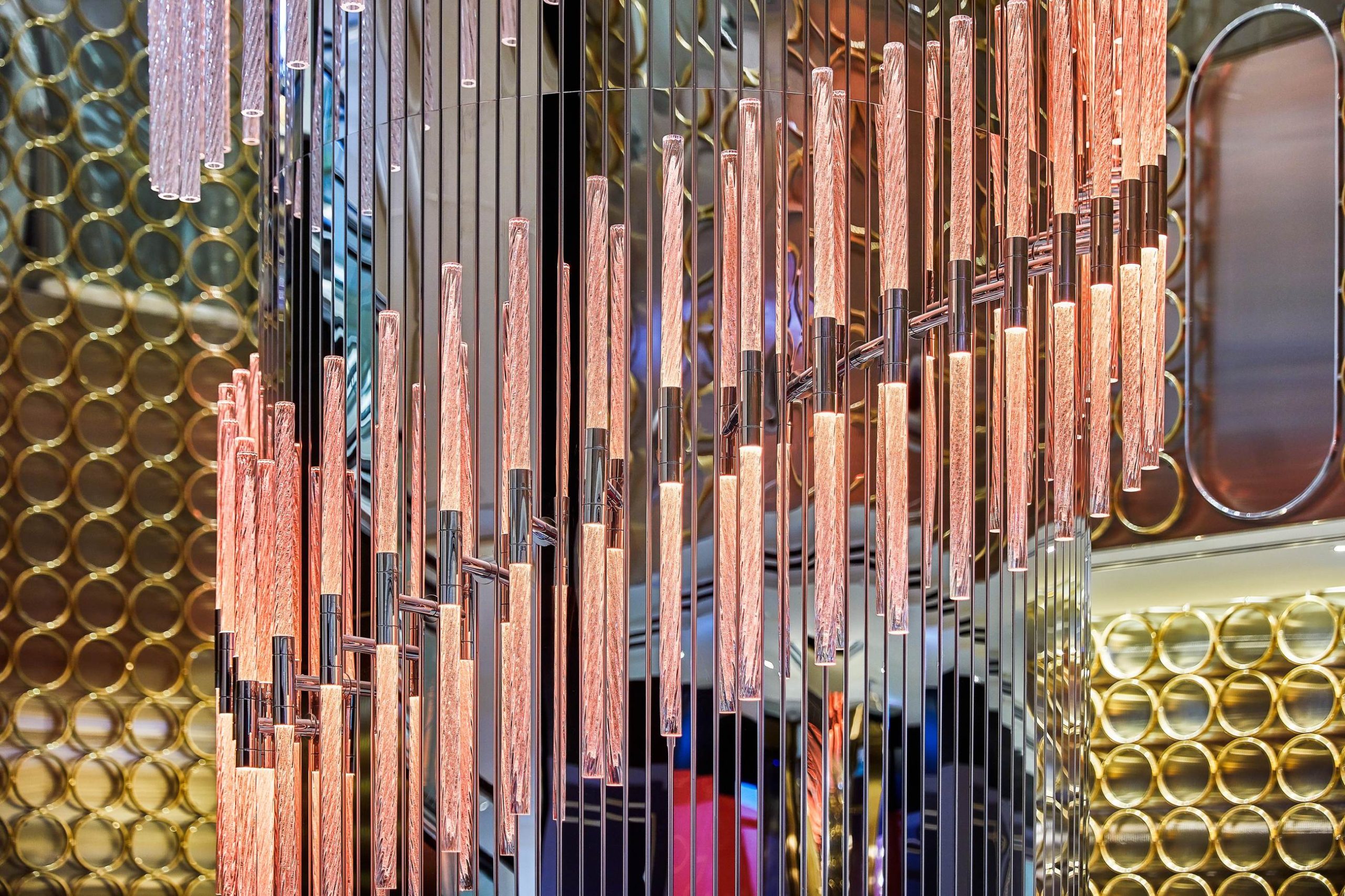 Crystal light fixture reflecting across a resort interior, Sydney