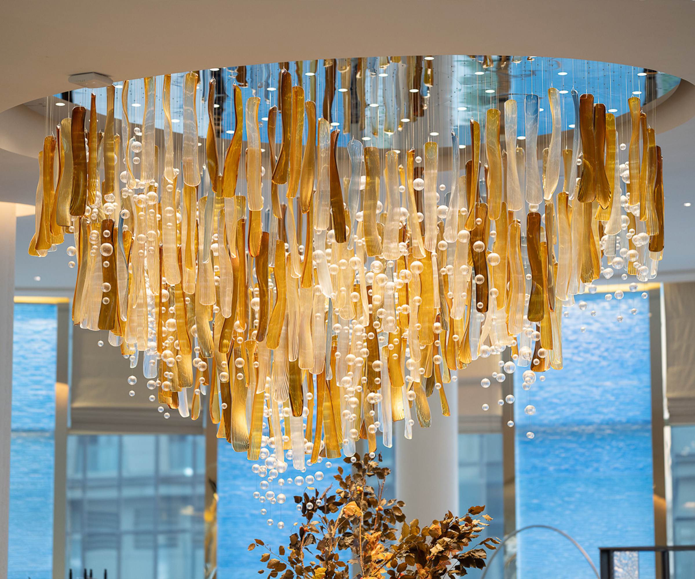 AURELIA chandelier seen from below, amber blades and clear spheres together
