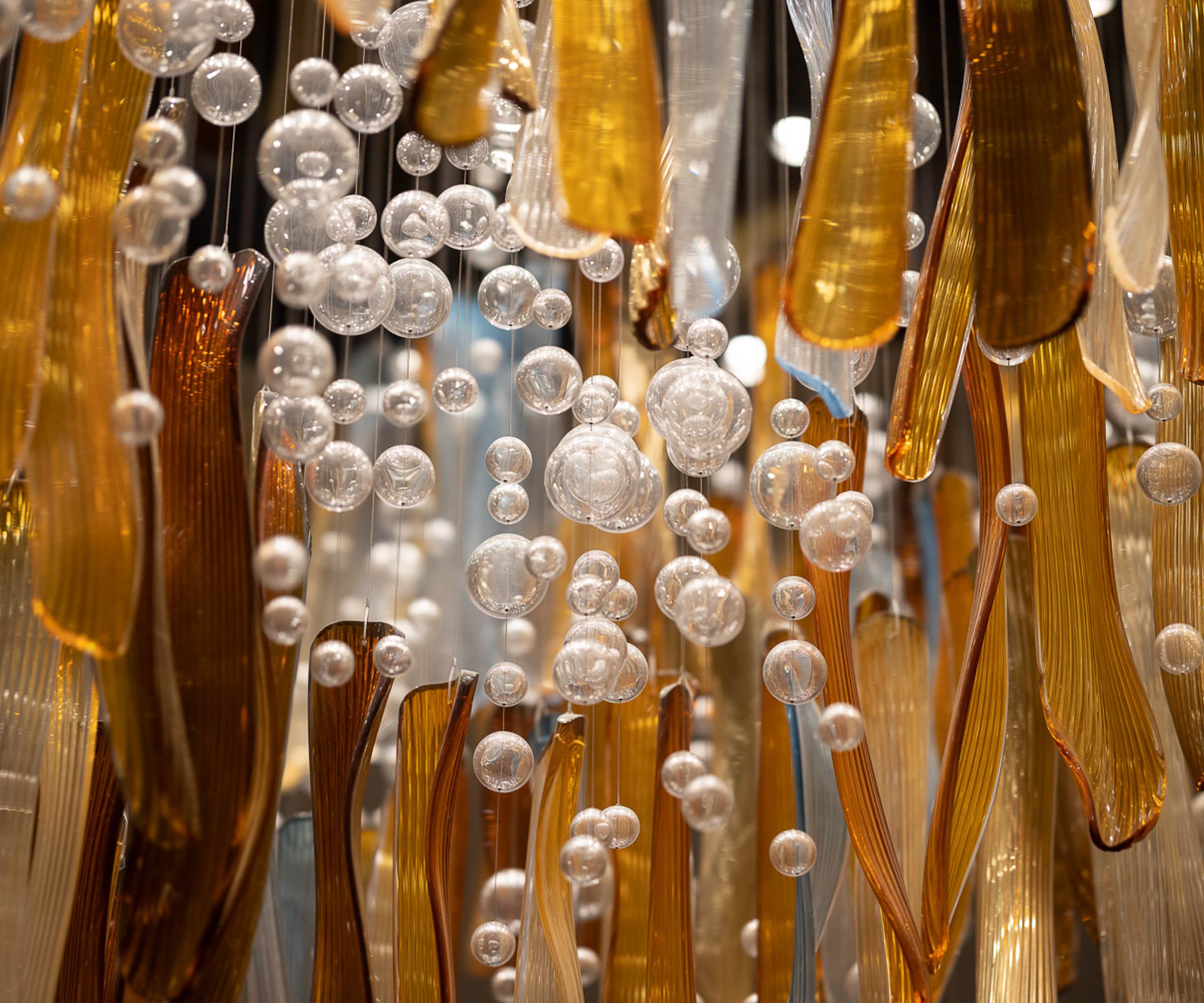 AURELIA amber glass blades in close view with the sphere strings behind